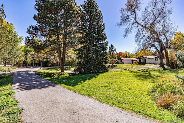 a view of yard with swimming pool and green space