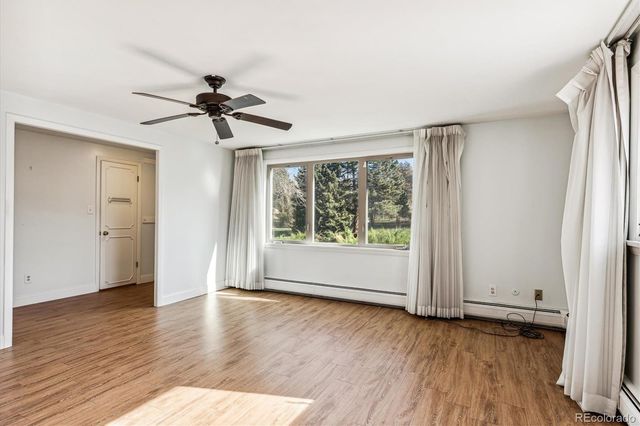 a view of room with hardwood floor and ceiling fan