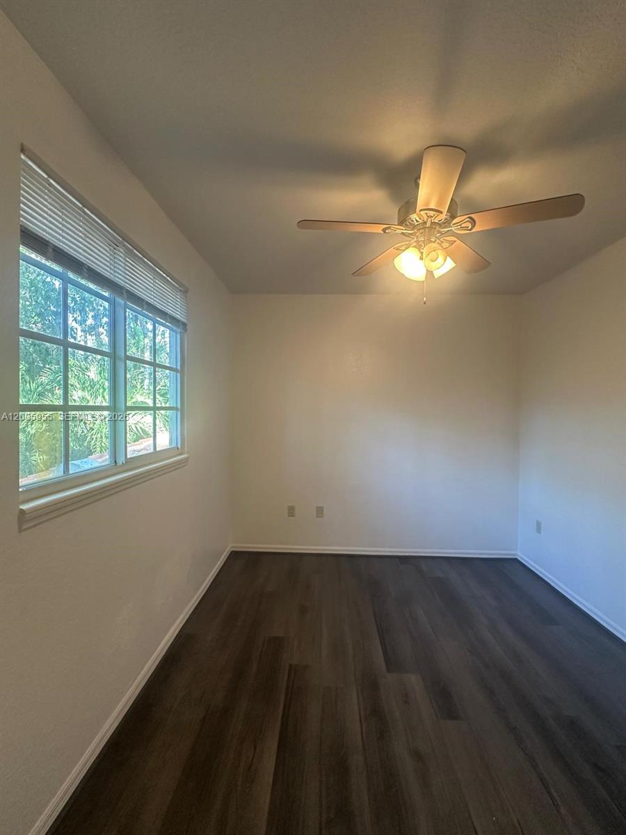 6920 West Sample Road, Unit 6920 Pompano Beach, FL 33063 - Photo 10 of 30 an empty room with a window