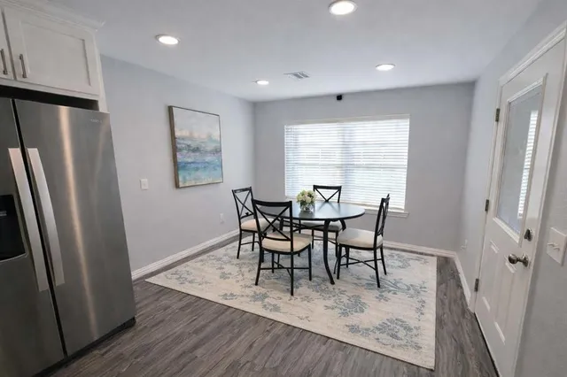 a view of a dining room with furniture and a window