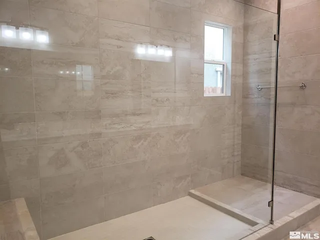 a bathroom with double sink and a mirror