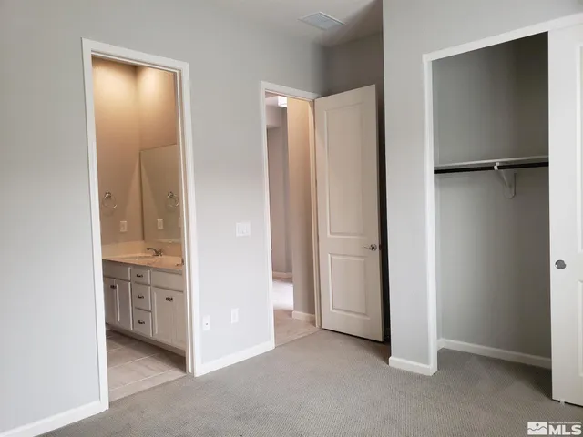 a white toilet sitting next to a white sink