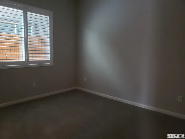 a kitchen with granite countertop white cabinets and a sink