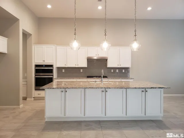 a view of a kitchen with a sink and dishwasher next to a window