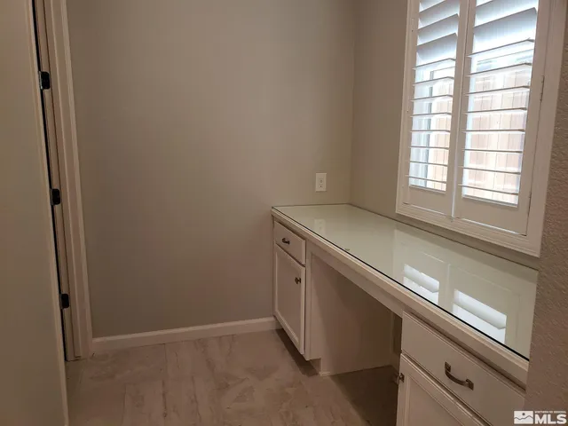 a kitchen with kitchen island granite countertop a stove a sink and a refrigerator