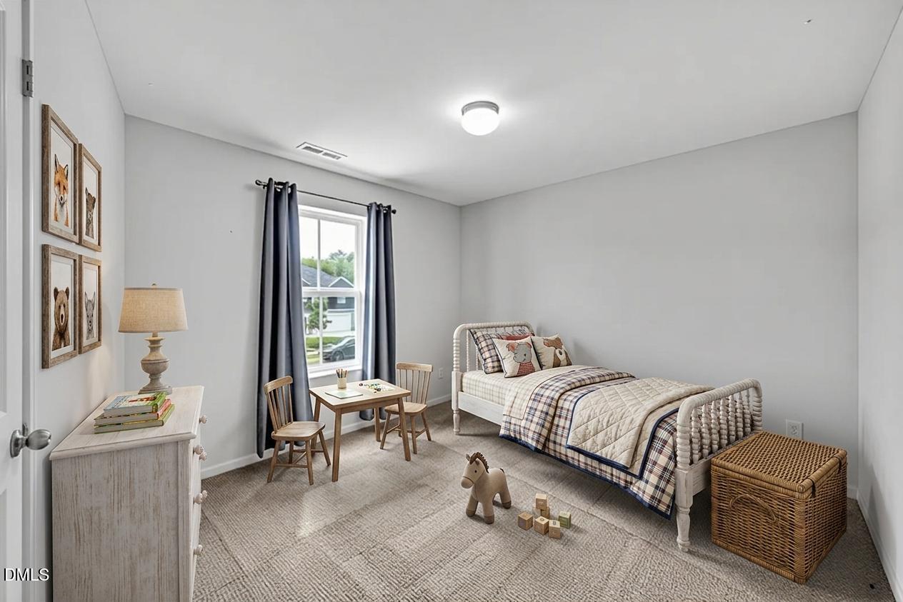 177 Yellowwood Avenue Spring Hope, NC 27882 - Photo 4 of 31 a bedroom with a bed and a window
