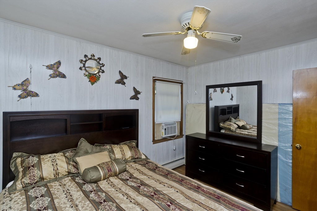 119 Kane Street Springfield, MA 01119 - Photo 6 of 23 a bedroom with a bed and a chandelier