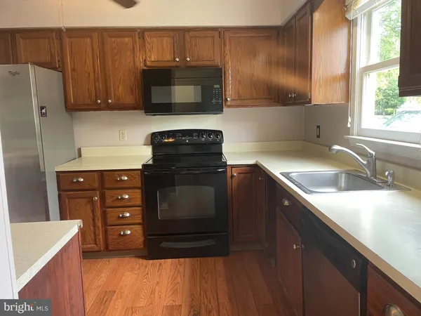 a kitchen with stainless steel appliances granite countertop a sink stove and microwave
