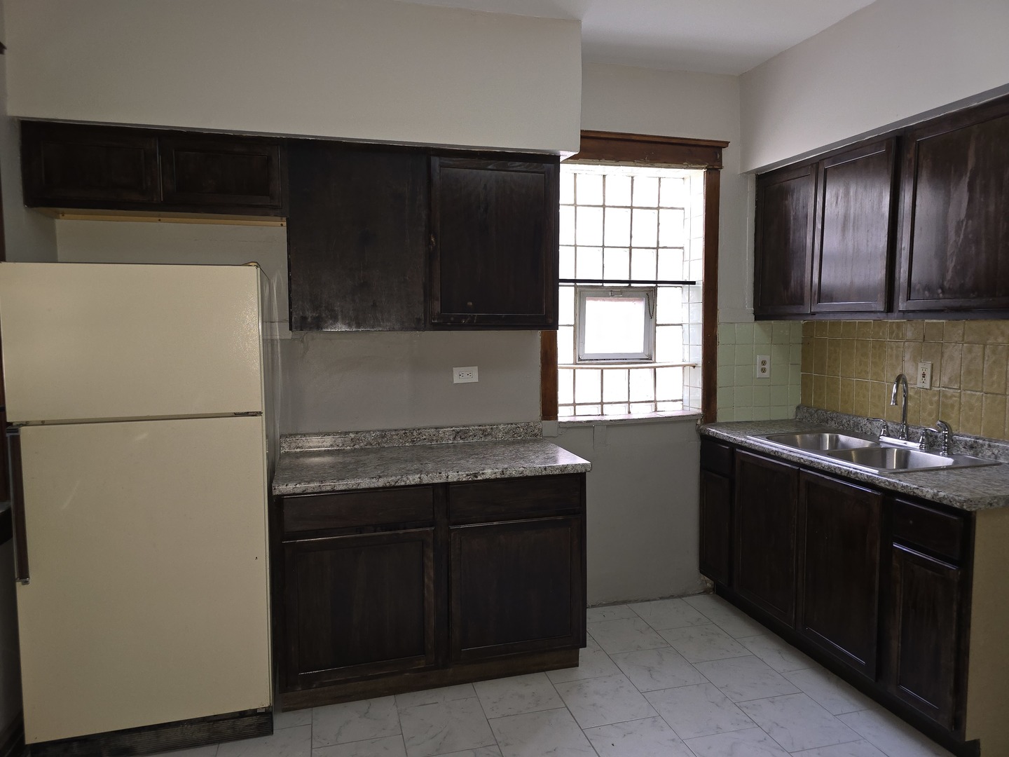 7517 South Green Street Chicago, IL 60620 - Photo 11 of 22 a kitchen with granite countertop a refrigerator and a stove