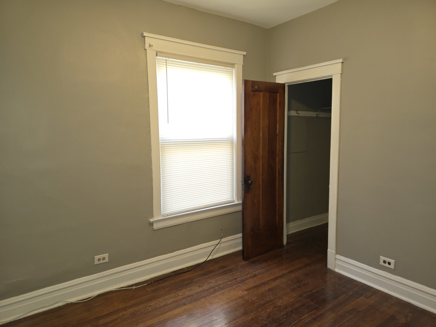 7517 South Green Street Chicago, IL 60620 - Photo 17 of 22 an empty room with wooden floor and a window
