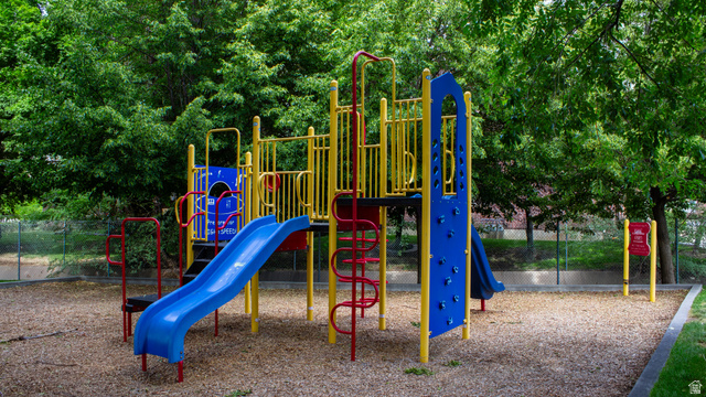 1115 North Main Street Bountiful, UT 84010 - Photo 7 of 17 Outdoor play area featuring a multi-level playset with blue slides, yellow and red accents, and climbing elements