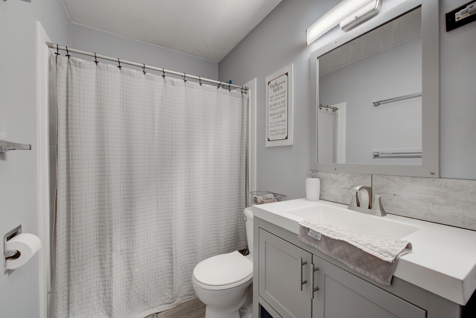 623 West Romeo Road Romeoville, IL 60446 - Photo 12 of 19 a bathroom with a sink a toilet and shower curtain