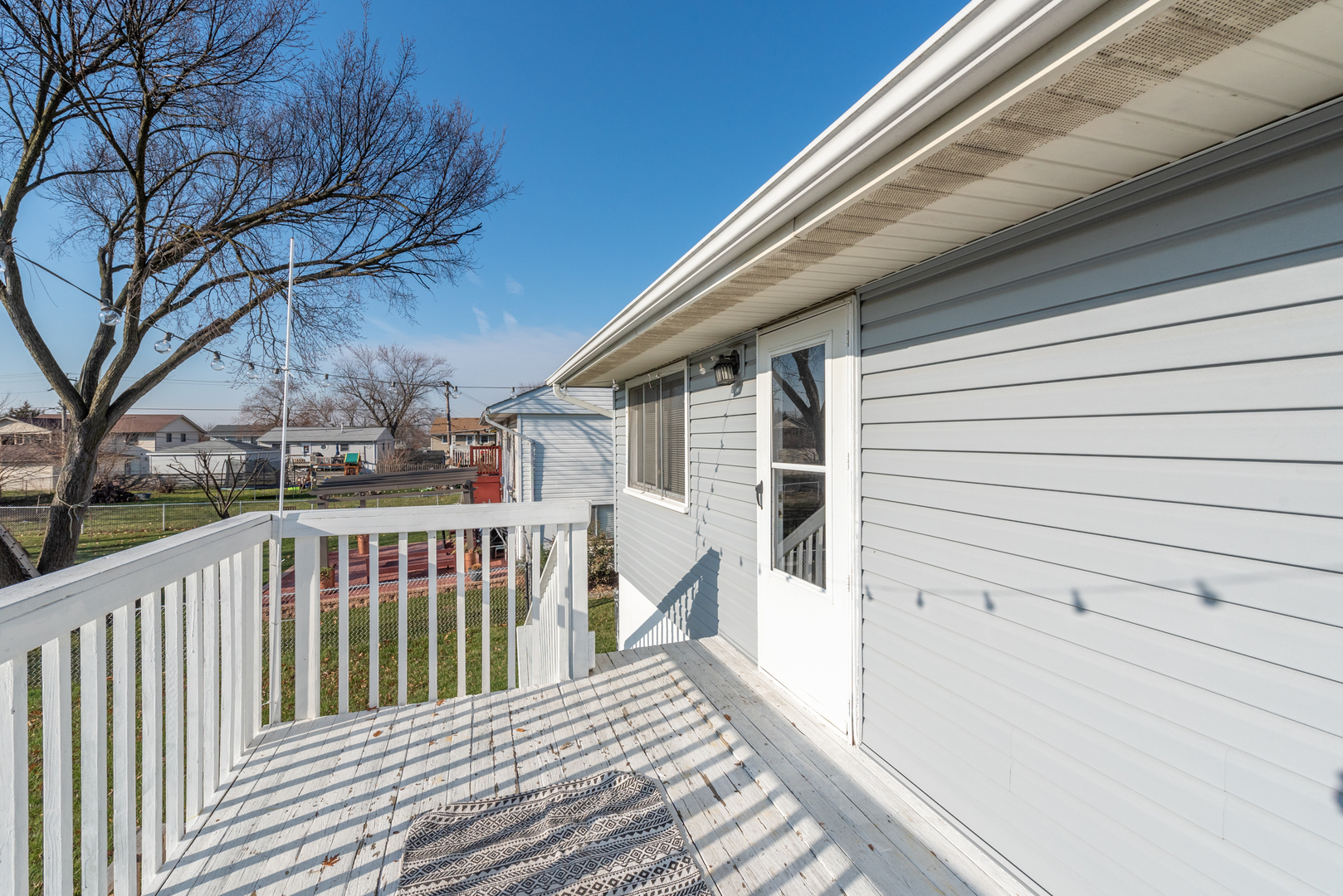623 West Romeo Road Romeoville, IL 60446 - Photo 13 of 19 a view of a house with a wooden fence