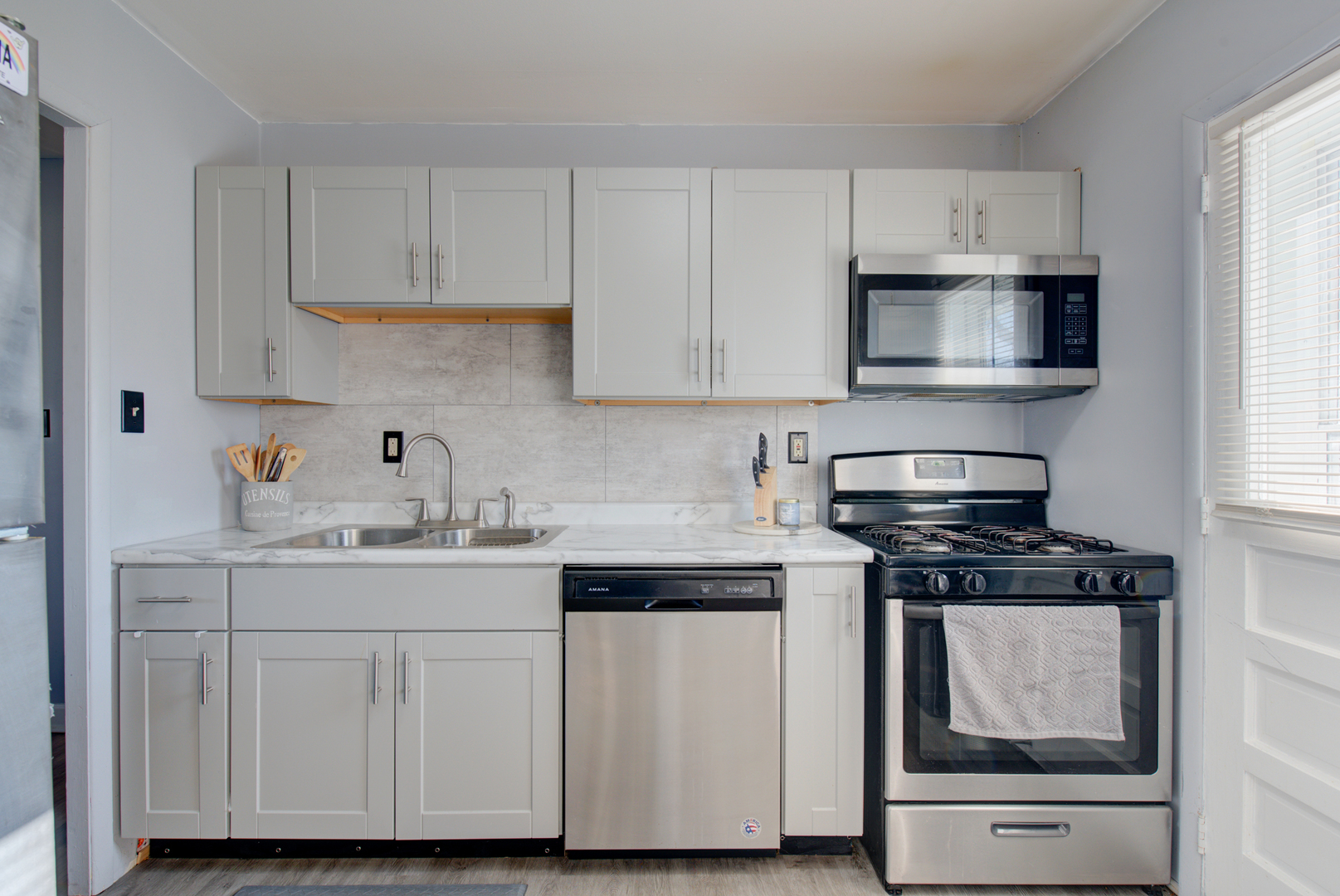623 West Romeo Road Romeoville, IL 60446 - Photo 6 of 19 a kitchen with white cabinets and appliances