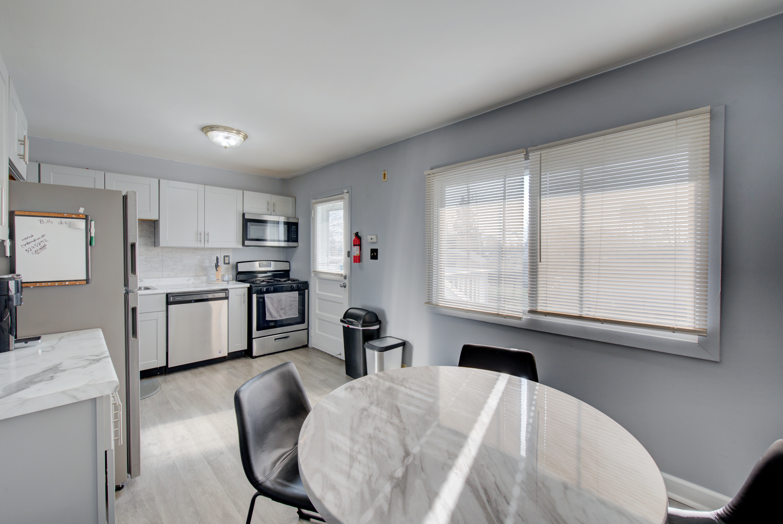 623 West Romeo Road Romeoville, IL 60446 - Photo 7 of 19 a kitchen with granite countertop white cabinets and stainless steel appliances