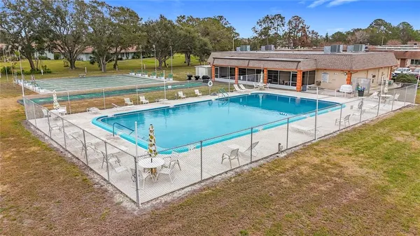 a view of a swimming pool with an outdoor seating