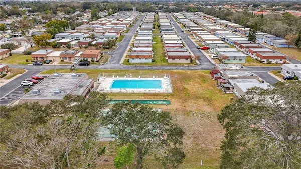 an aerial view of residential houses with yard