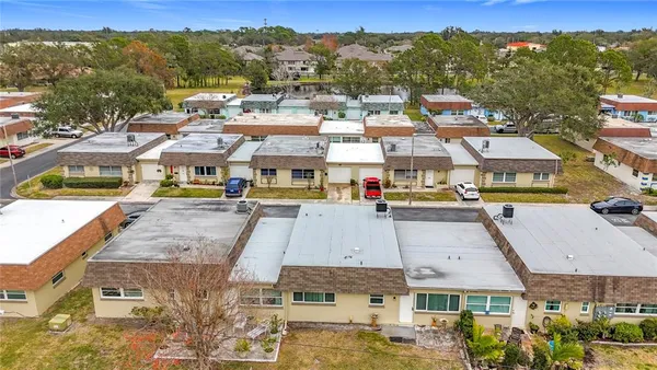 an aerial view of residential houses with yard