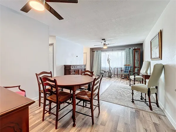 a view of a dining room with furniture and wooden floor