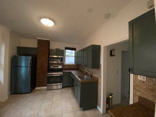 a kitchen with a refrigerator and a sink