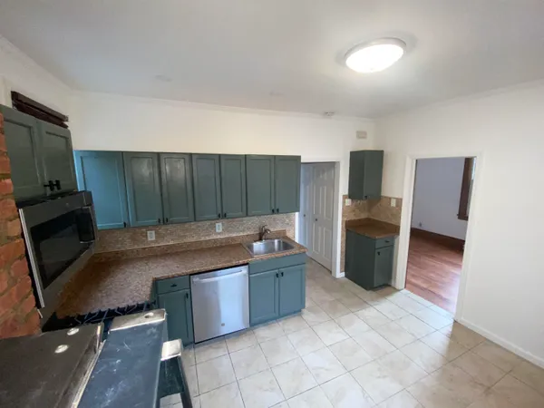 a view of a kitchen with refrigerator and microwave