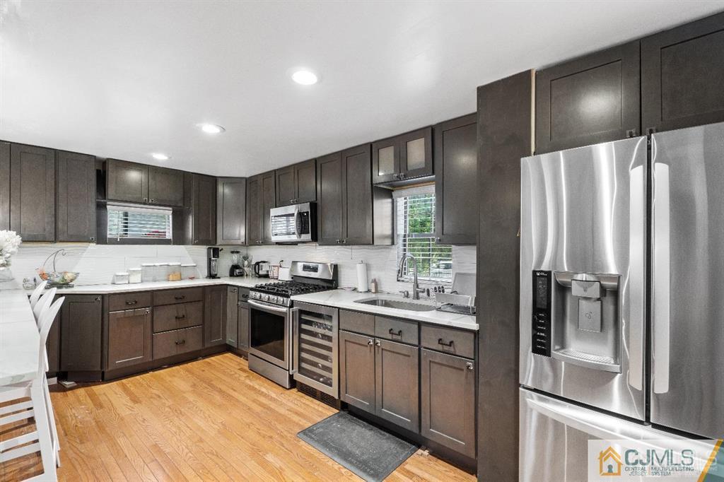 701 Spruce Street Roselle, NJ 07203 - Photo 12 of 28 a large kitchen with cabinets and stainless steel appliances