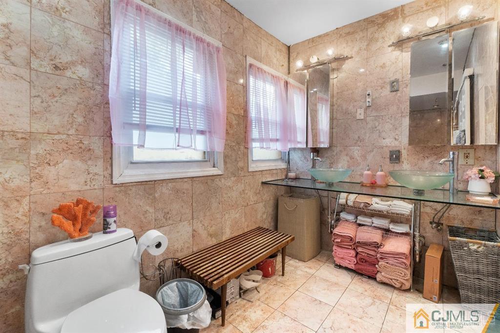 701 Spruce Street Roselle, NJ 07203 - Photo 26 of 28 a bathroom with a sink mirror vanity and toilet