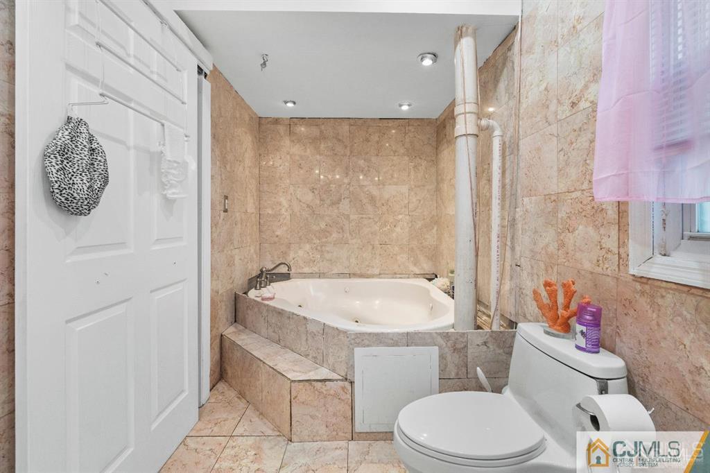 701 Spruce Street Roselle, NJ 07203 - Photo 27 of 28 a bathroom with a sink a toilet and a shower