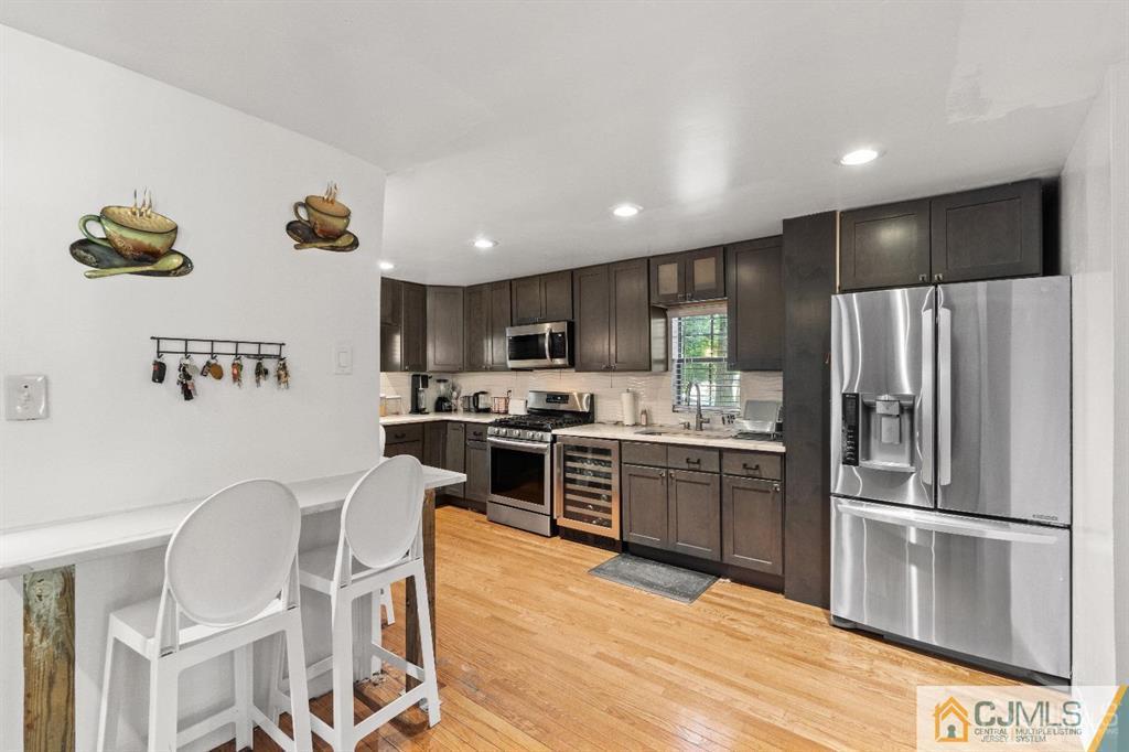 701 Spruce Street Roselle, NJ 07203 - Photo 10 of 28 a kitchen with granite countertop stainless steel appliances a refrigerator and a stove top oven