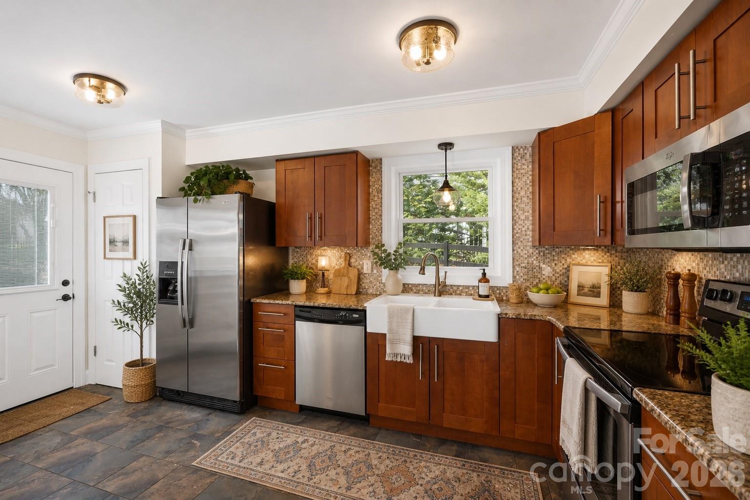 16149 Haroa Court Fort Mill, SC 29708 - Photo 8 of 43 a kitchen with stainless steel appliances granite countertop a refrigerator a stove a sink and a microwave