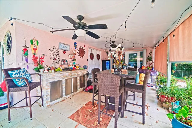 a view of a dining room with furniture and a potted plant
