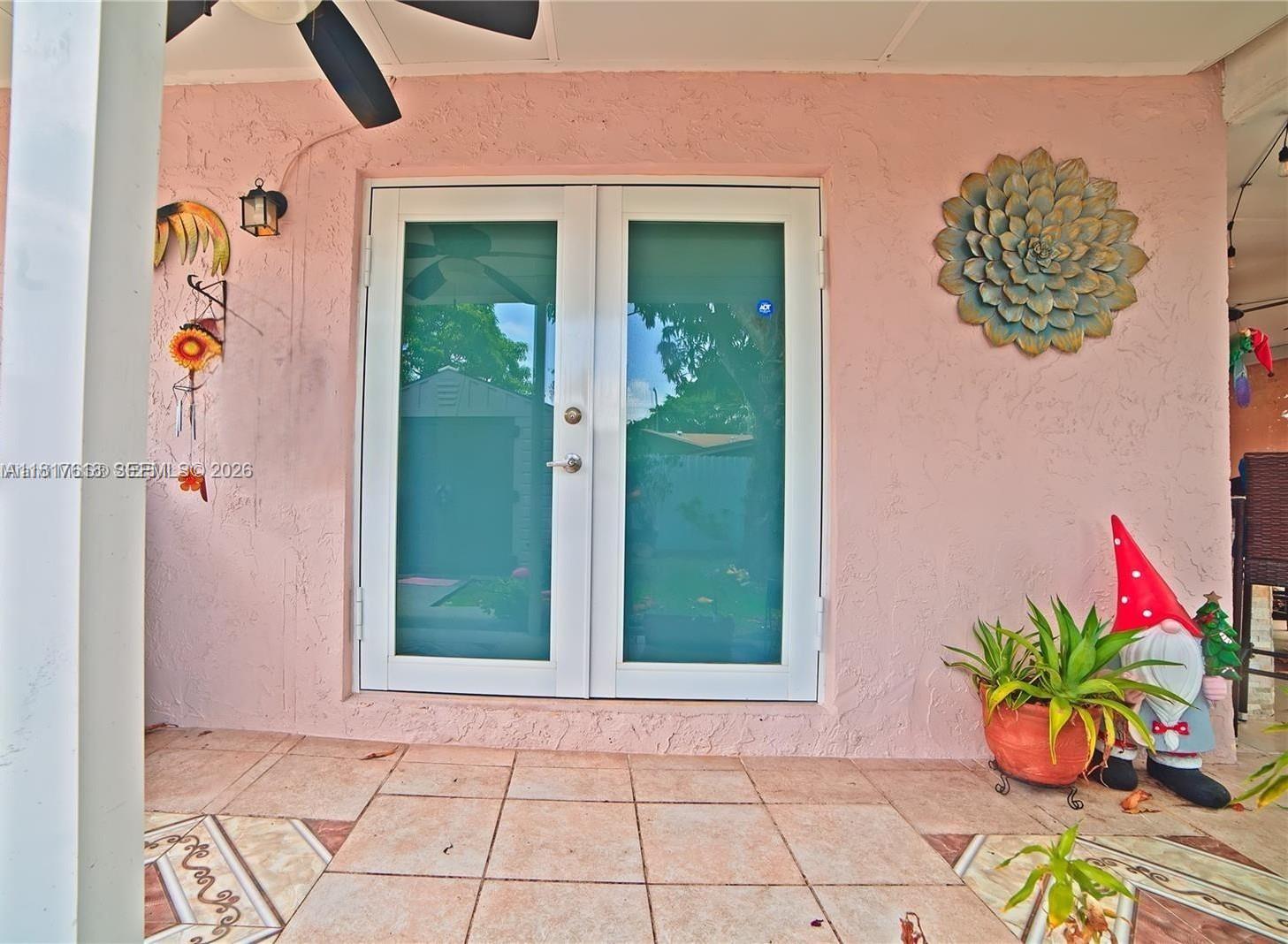 10471 Southwest 174th Terrace Miami, FL 33157 - Photo 3 of 23 an entryway with a flower pot and a potted plant