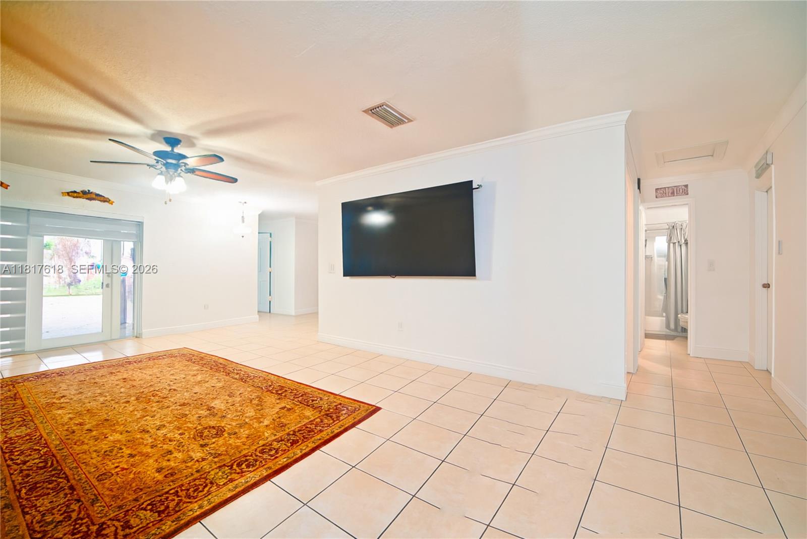 10471 Southwest 174th Terrace Miami, FL 33157 - Photo 4 of 23 a view of a livingroom with a flat screen tv