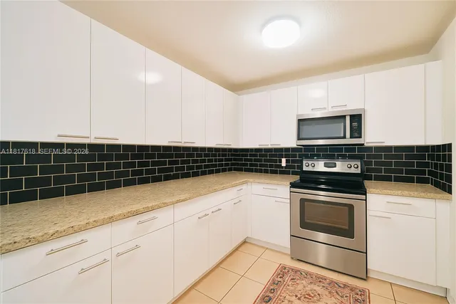 a kitchen with granite countertop a sink and a stove