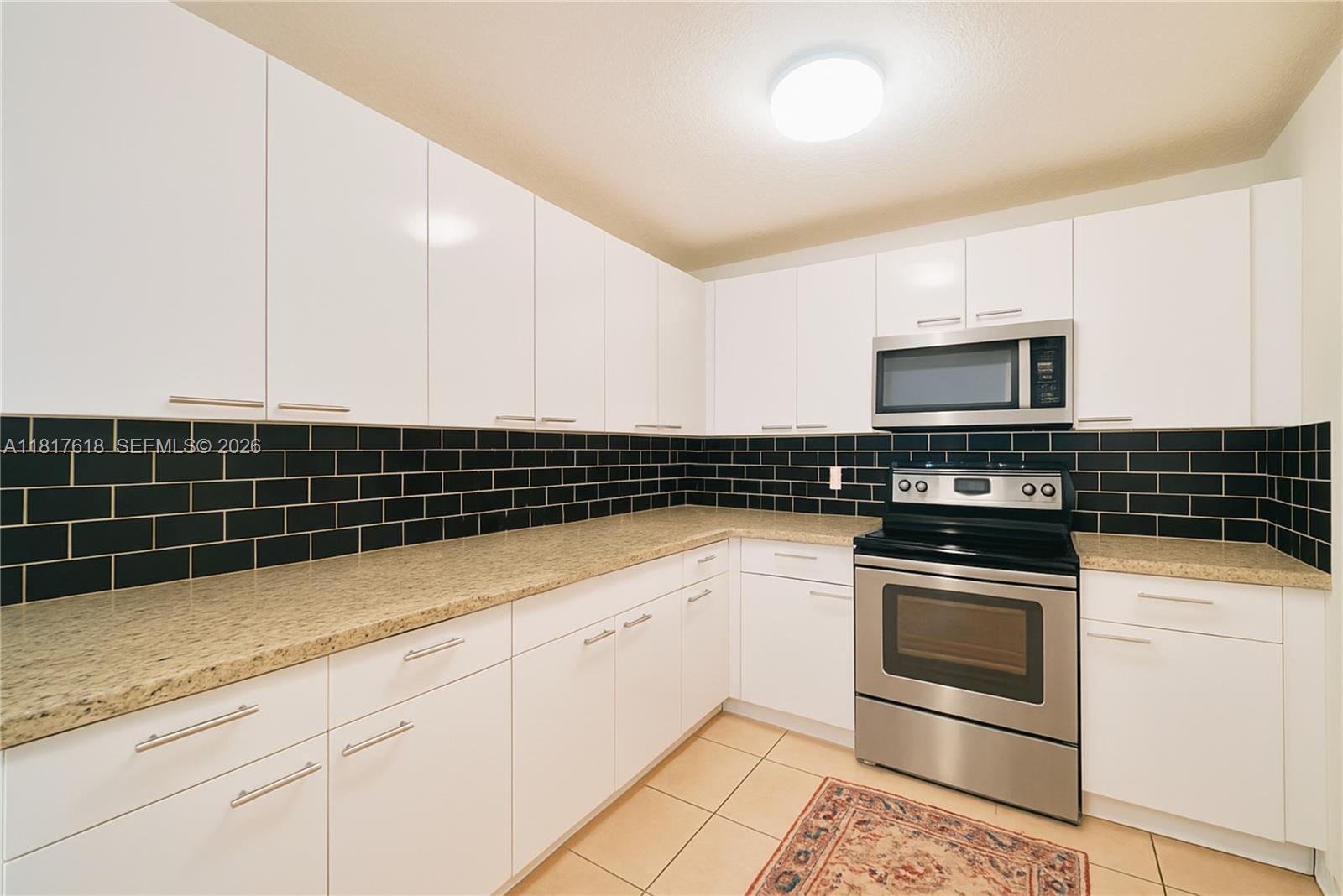 10471 Southwest 174th Terrace Miami, FL 33157 - Photo 6 of 23 a kitchen with granite countertop a sink and a stove