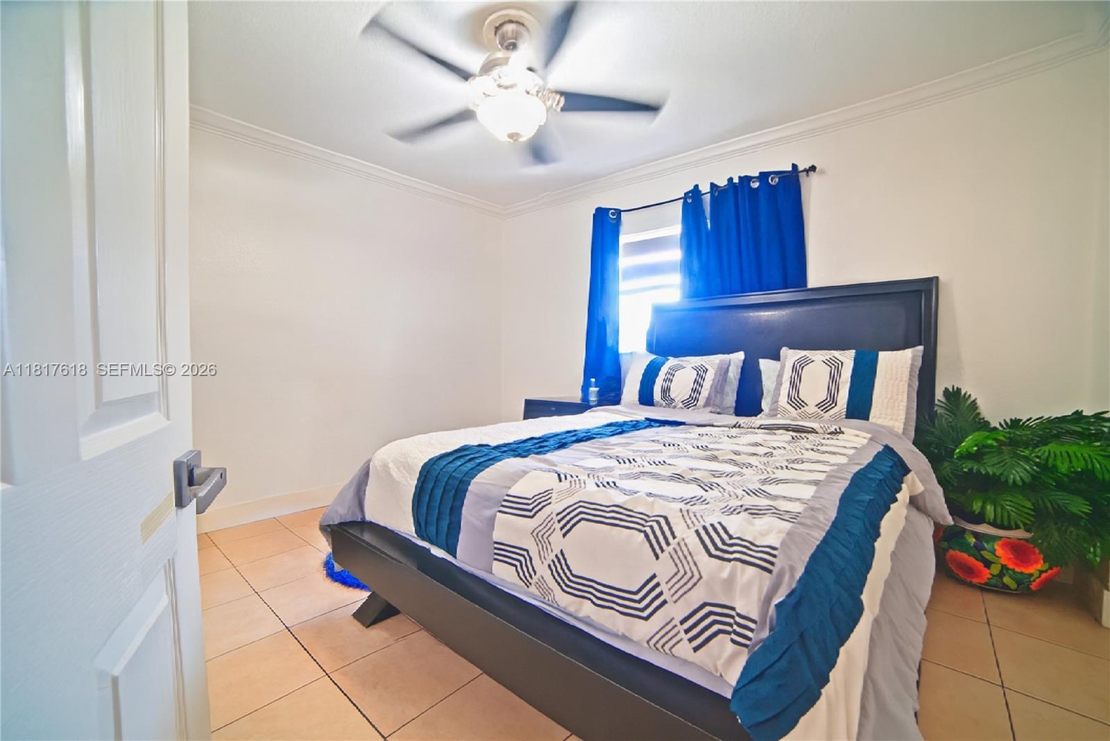 10471 Southwest 174th Terrace Miami, FL 33157 - Photo 8 of 23 a bedroom with a bed and a chandelier