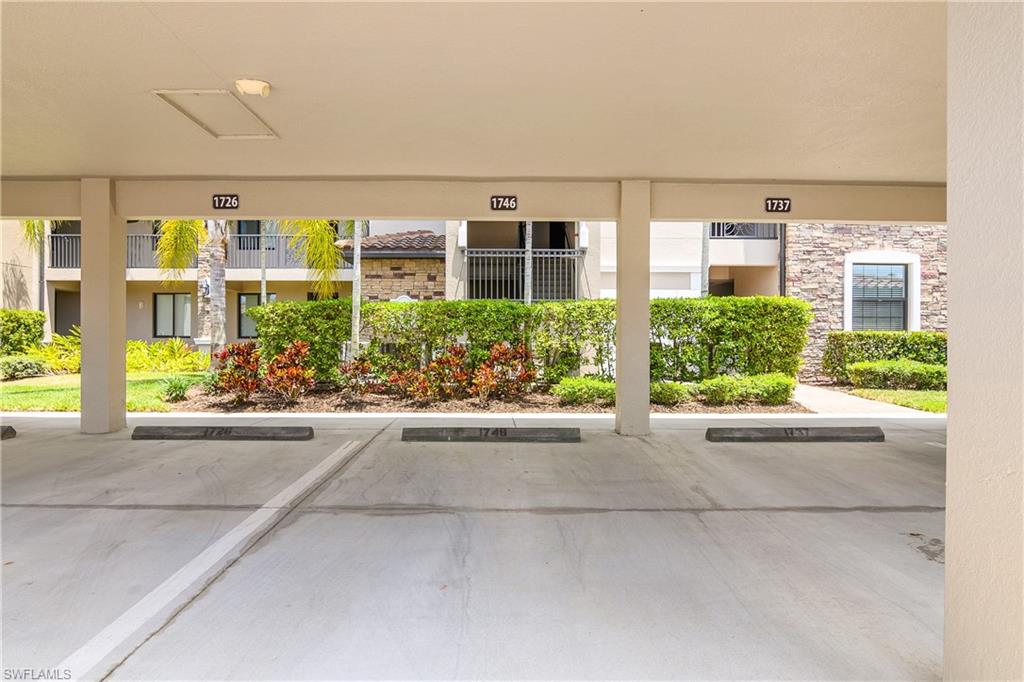 9834 Giaveno Circle, Unit 1746 Naples, FL 34113 - Photo 24 of 41 a front view of a building with garden