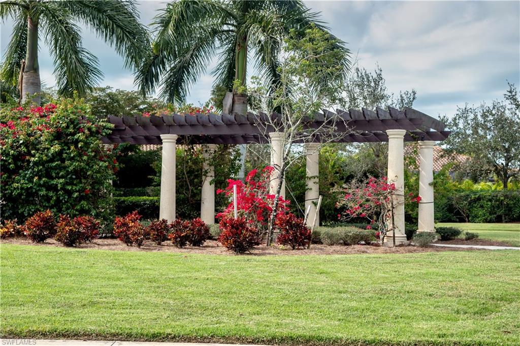 9834 Giaveno Circle, Unit 1746 Naples, FL 34113 - Photo 26 of 41 a view of a backyard with plants and a patio