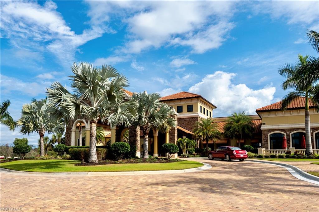 9834 Giaveno Circle, Unit 1746 Naples, FL 34113 - Photo 30 of 41 a front view of a house with a yard