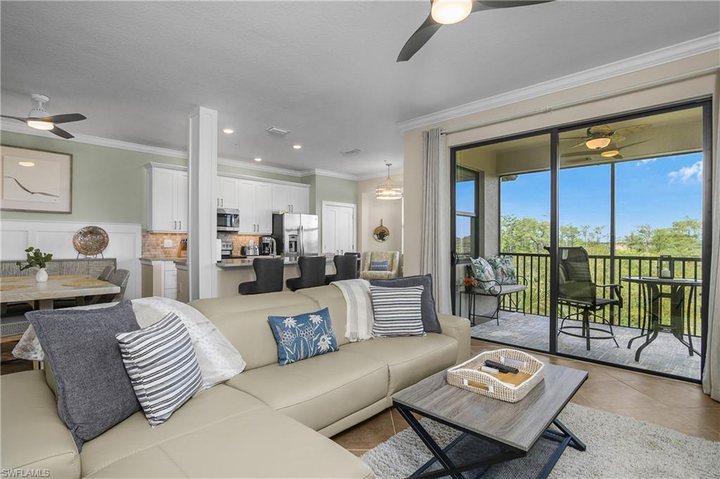 9834 Giaveno Circle, Unit 1746 Naples, FL 34113 - Photo 3 of 41 a living room with furniture and a large window