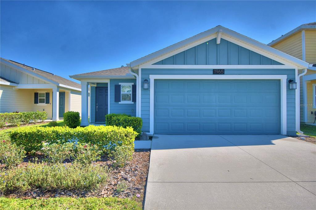 1965 Traverse Way Kissimmee, FL 34746 - Photo 1 of 1 a front view of a house with a yard and garage