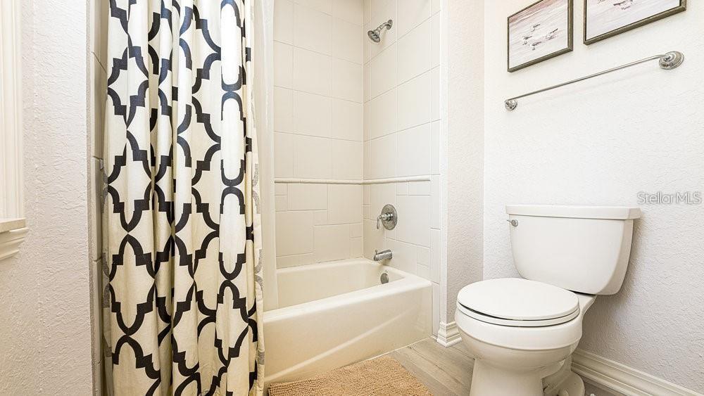 7650 Whisper Way, Unit 304 Reunion, FL 34747 - Photo 15 of 37 a bathroom with a toilet and a bathtub