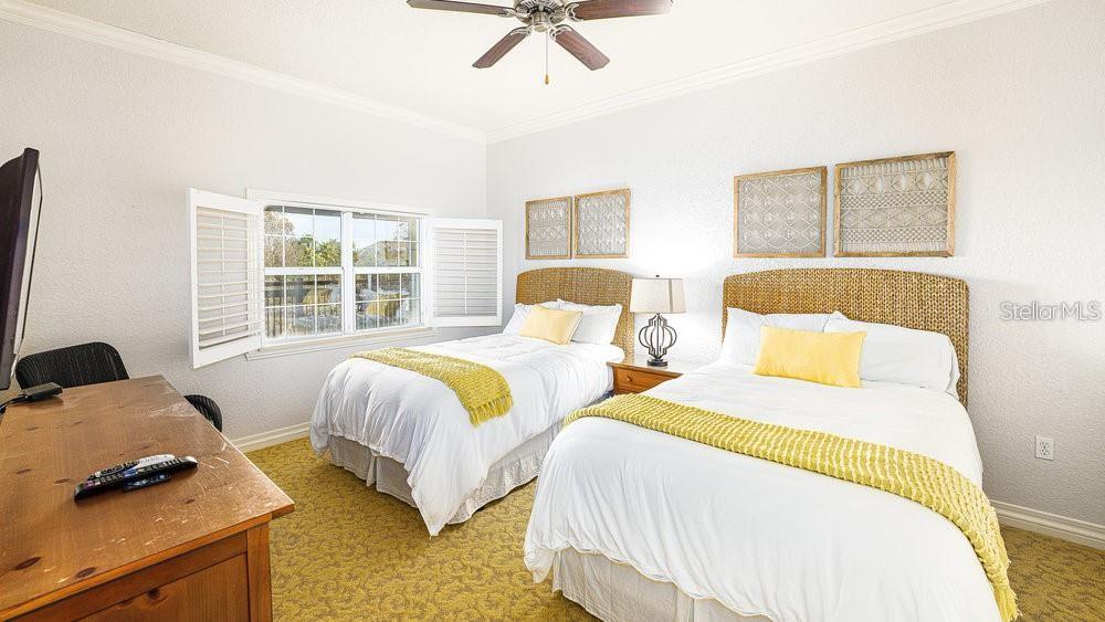 7650 Whisper Way, Unit 304 Reunion, FL 34747 - Photo 16 of 37 a bedroom with two beds and a window