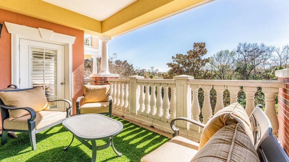 7650 Whisper Way, Unit 304 Reunion, FL 34747 - Photo 20 of 37 a balcony with table and chairs