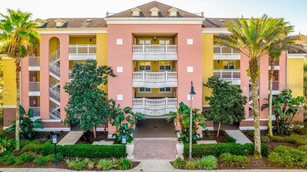 7650 Whisper Way, Unit 304 Reunion, FL 34747 - Photo 22 of 37 front view of a brick house with a yard
