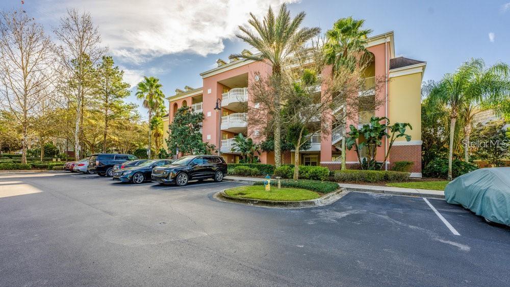 7650 Whisper Way, Unit 304 Reunion, FL 34747 - Photo 24 of 37 a view of a street with a cars parked