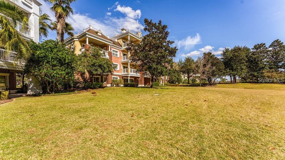 7650 Whisper Way, Unit 304 Reunion, FL 34747 - Photo 32 of 37 a front view of a house with a yard