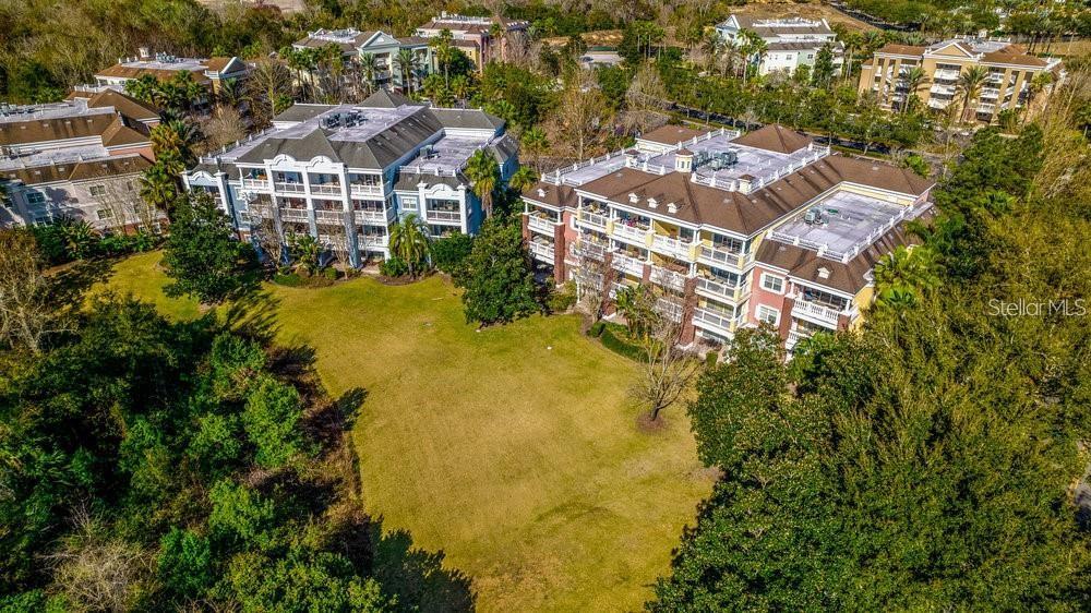 7650 Whisper Way, Unit 304 Reunion, FL 34747 - Photo 35 of 37 an aerial view of residential houses with swimming pool and green space