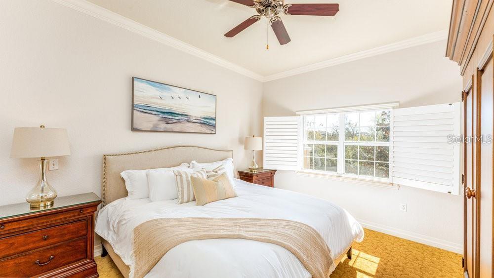 7650 Whisper Way, Unit 304 Reunion, FL 34747 - Photo 8 of 37 a bedroom with a bed and a window