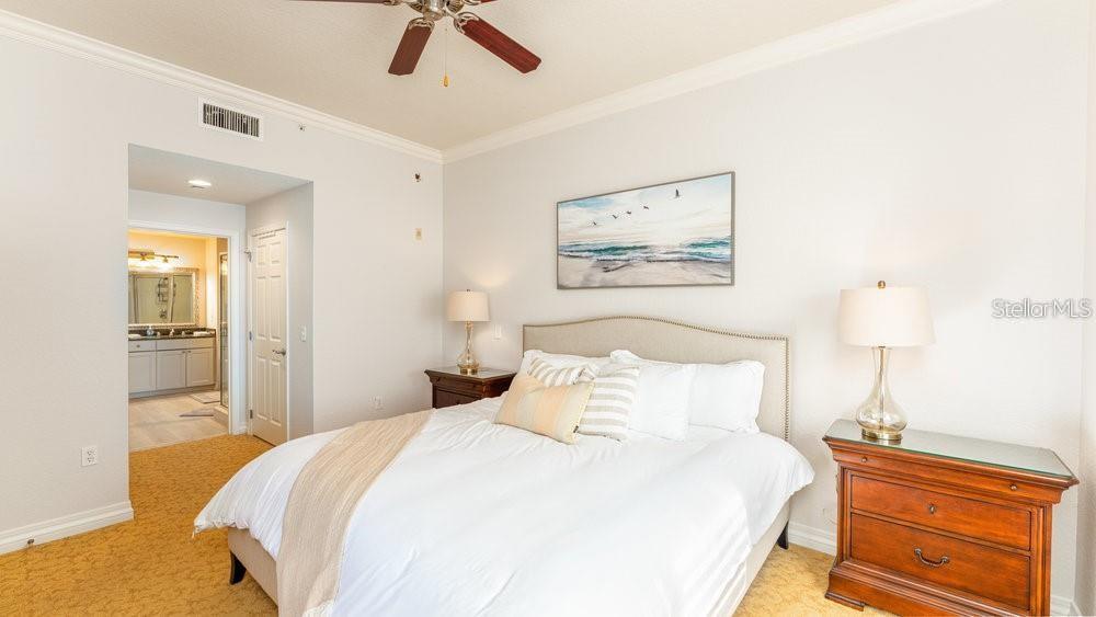 7650 Whisper Way, Unit 304 Reunion, FL 34747 - Photo 9 of 37 a bedroom with a bed and a painting on the wall